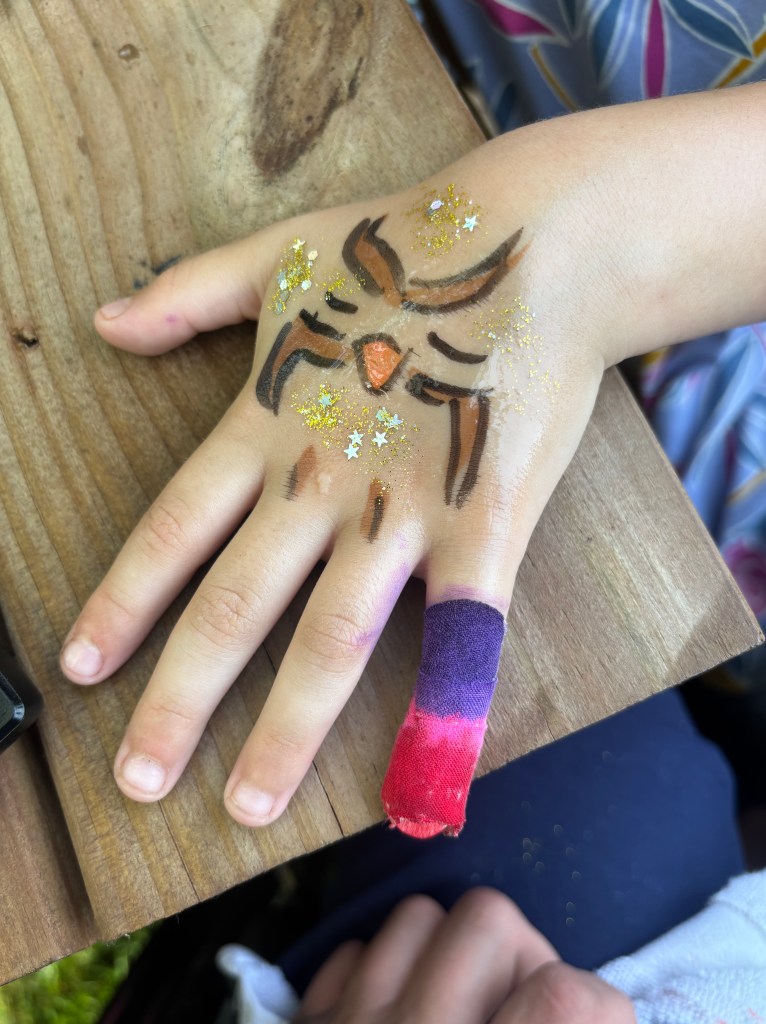 Owl painting on child's hand.